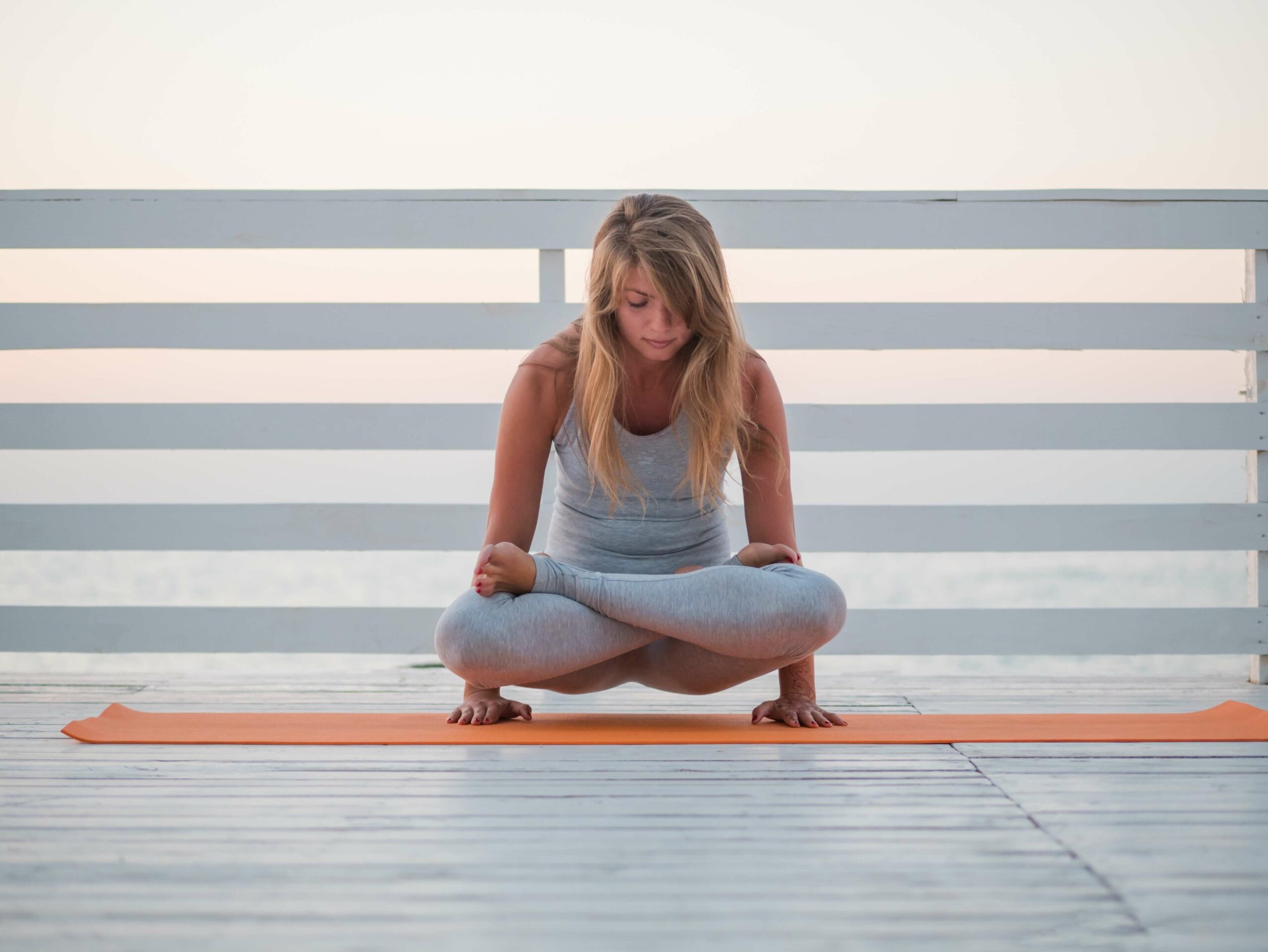 beautiful-portrait-of-woman-practicing-yoga-asana-on-white-wooden-beach-close-to-sea-in-sunrise_t20_koK9p2 (1)