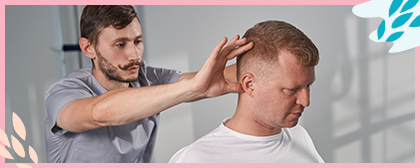 man in wheelchair getting a head massage