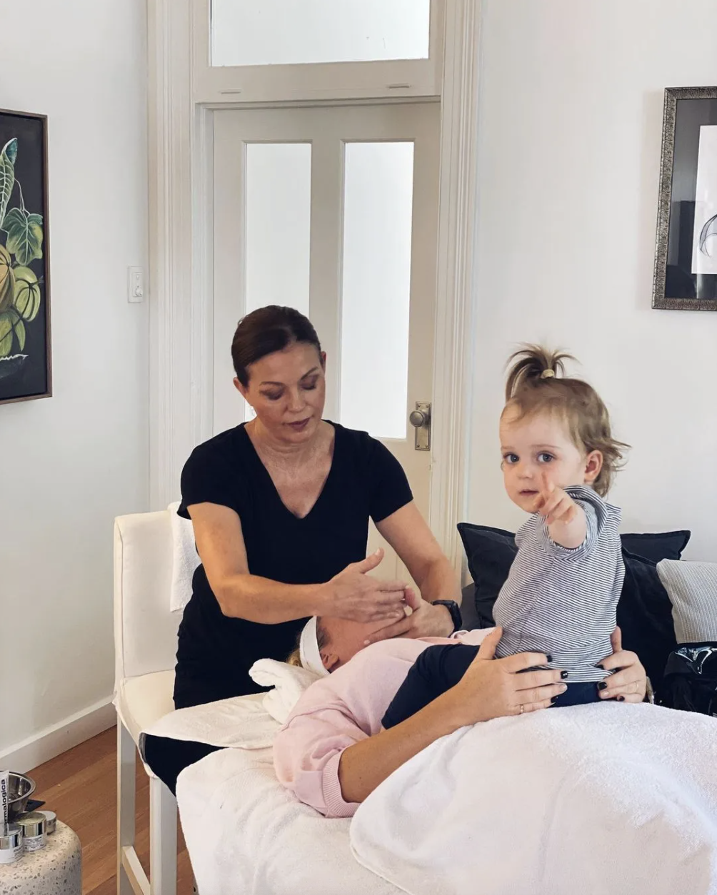 Ash Pollard receiving a Blys facial with her baby on her lap