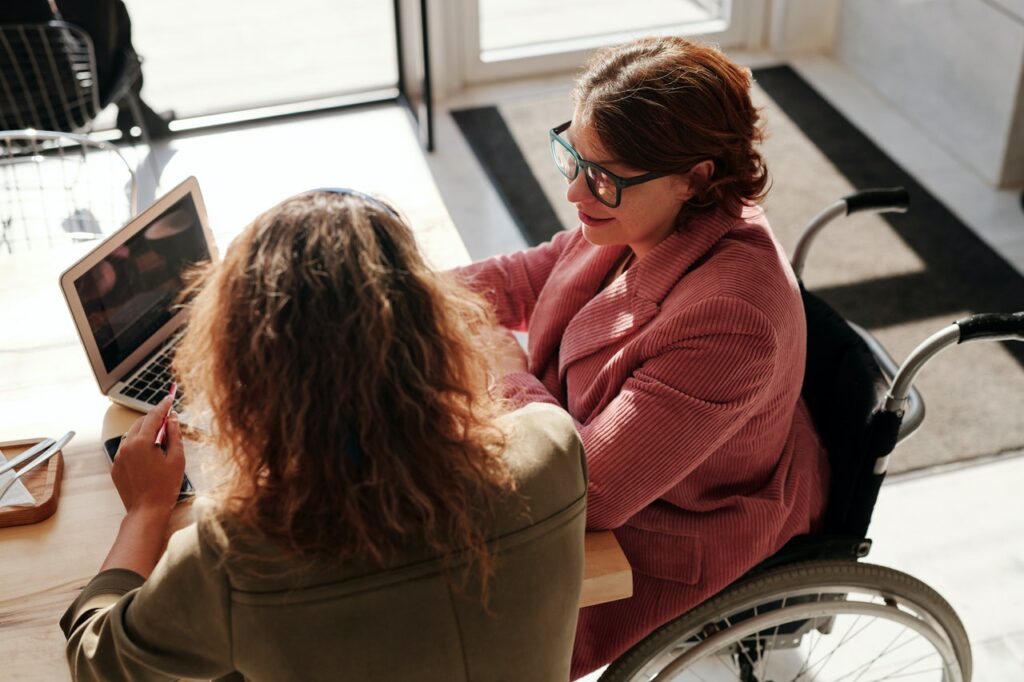 woman-in-red-sweater-wearing-black-framed-eyeglasses-sitting-on-wheelchair