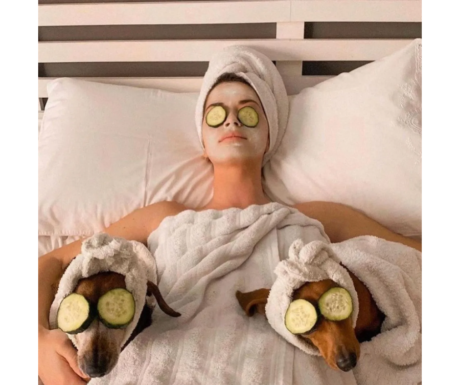 Woman and two dogs laying down with a face mask