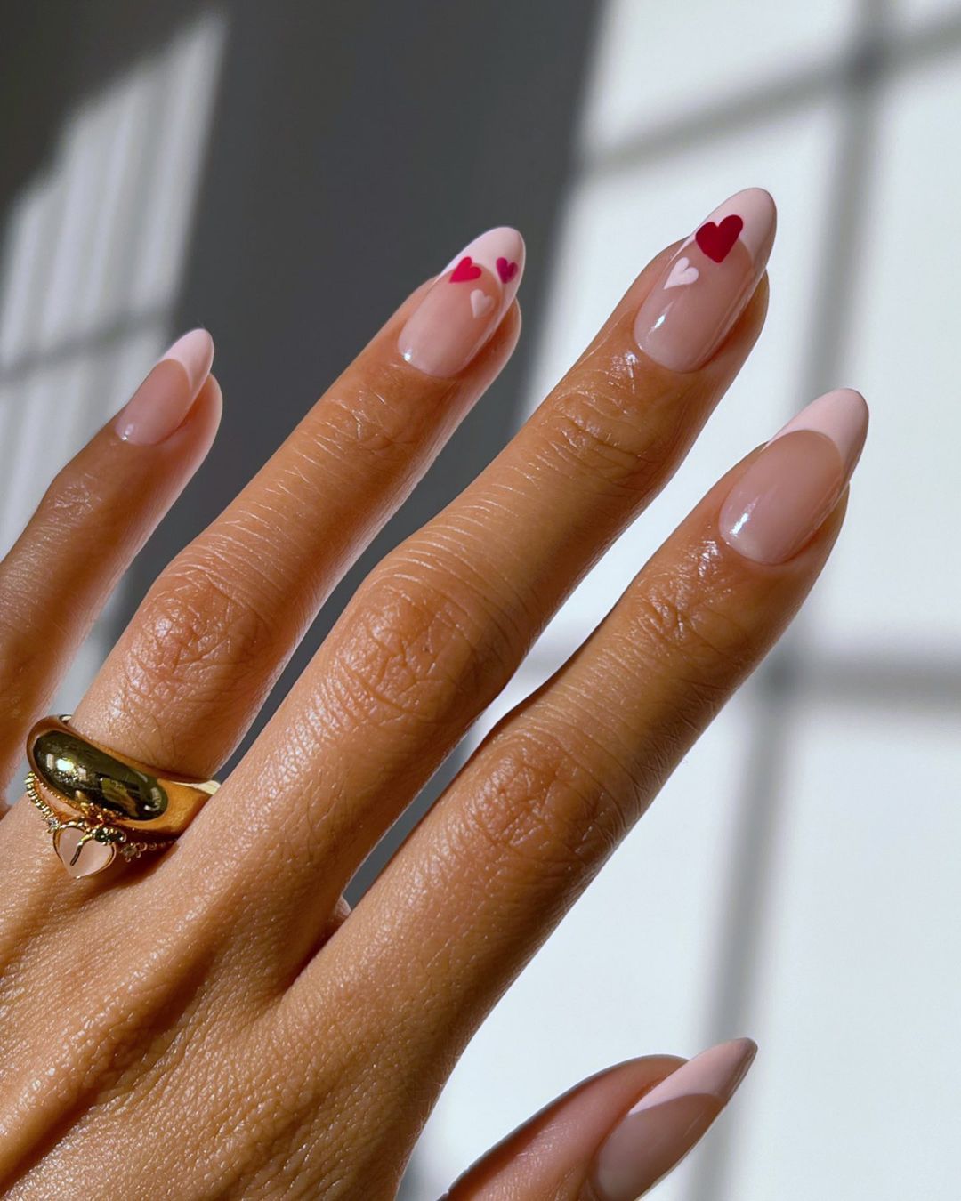 pink french tip manicure with red and pink hearts