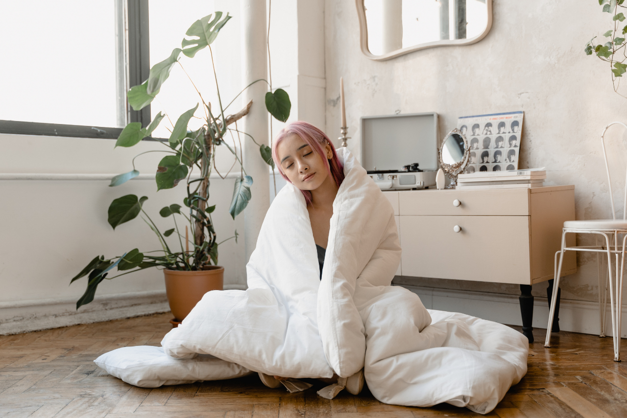 woman-in-white-robe-sitting-on-bed