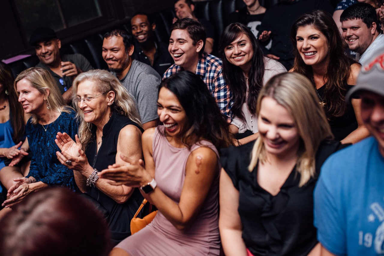 People laughing at a comedy show