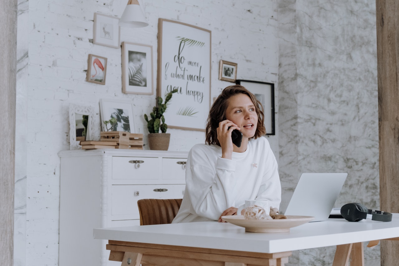 Best insurance options for massage therapist_ image of woman sitting behind desk talking on phone