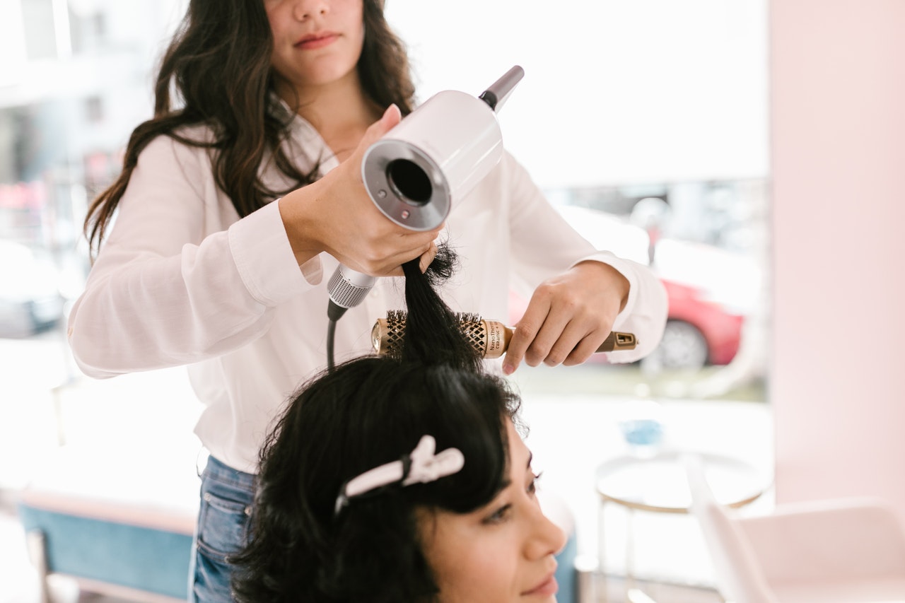 Hair dresser doing a clients hair