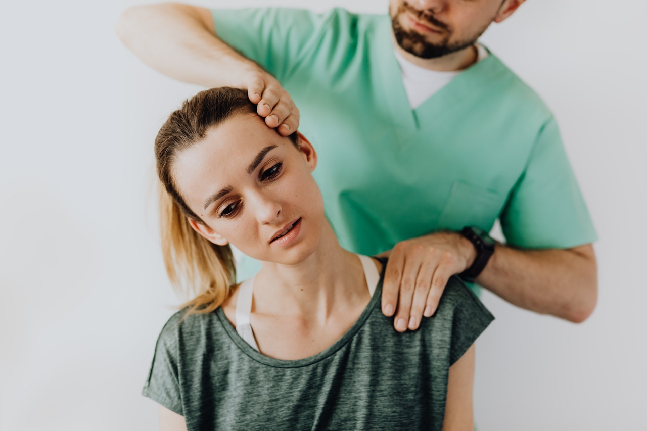 professional-massage-therapist-treating-a-female-patient-s-injured-neck