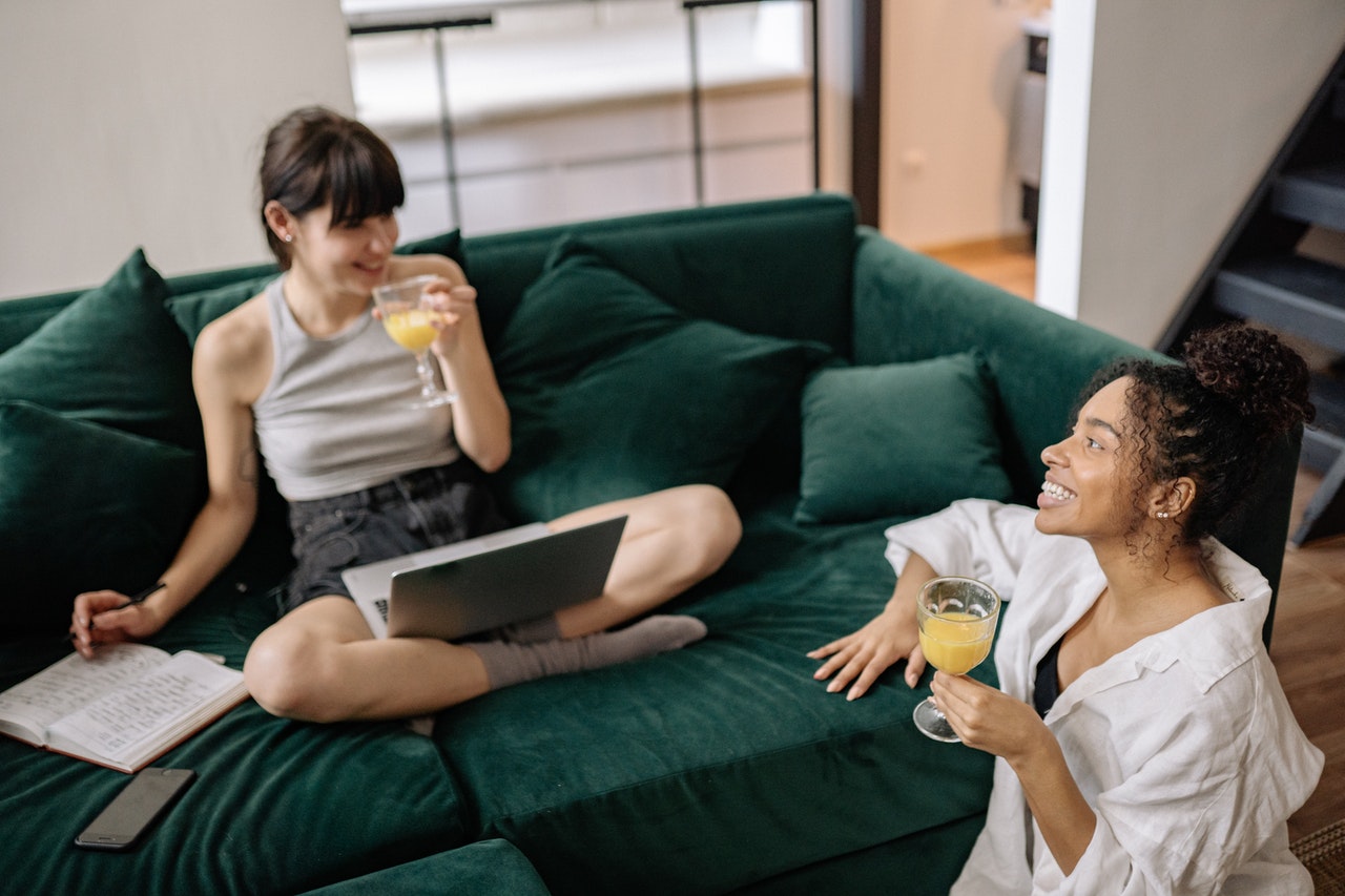 two-women-drinking-juice-while-talking