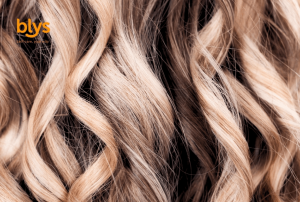 Close-up of balayage curls with soft waves and textured strands, creating a luxurious, warm, salon-inspired beauty mood.